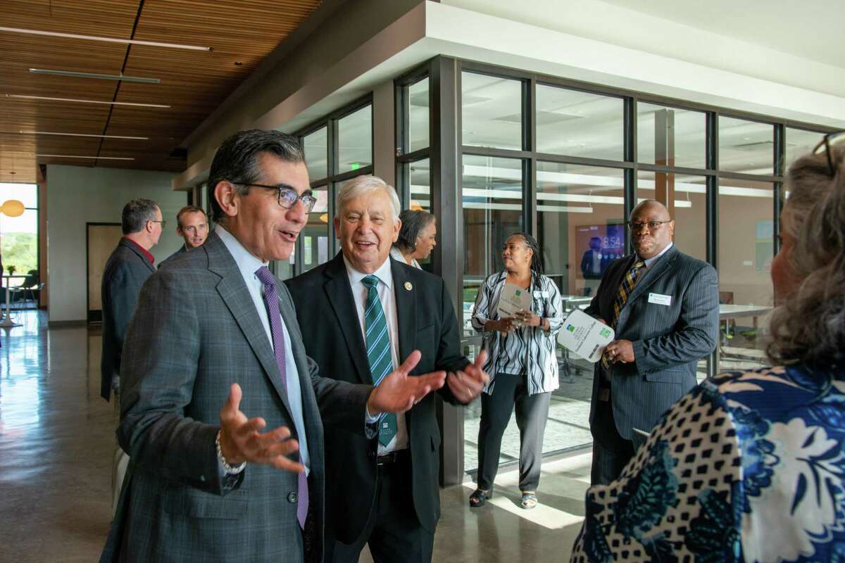 Dr. Mike Flores, Alamo Colleges chancellor, left, speaks with attendees at the Aug. 17 ribbon-cutting ceremony and opening of Northeast Lakeview College’s newest classroom and lab building, Paluxy Hall.