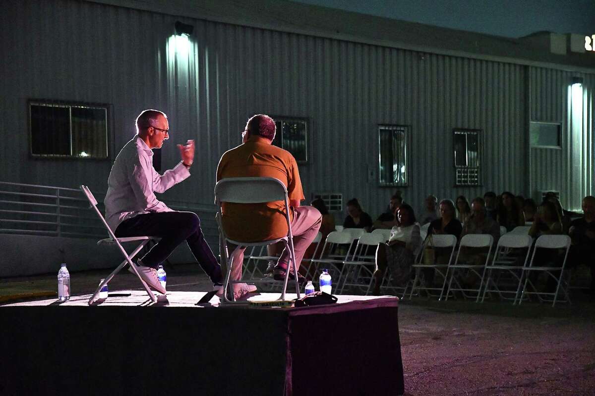 Visual artist Marcus Lyon, at left, answers questions from Fotofest executive director Steven Evans before a showing of Lyon’s “Fields of Vision” work at the Silos at Sawyer Yard Friday August 26,2022.(Dave Rossman photo)
