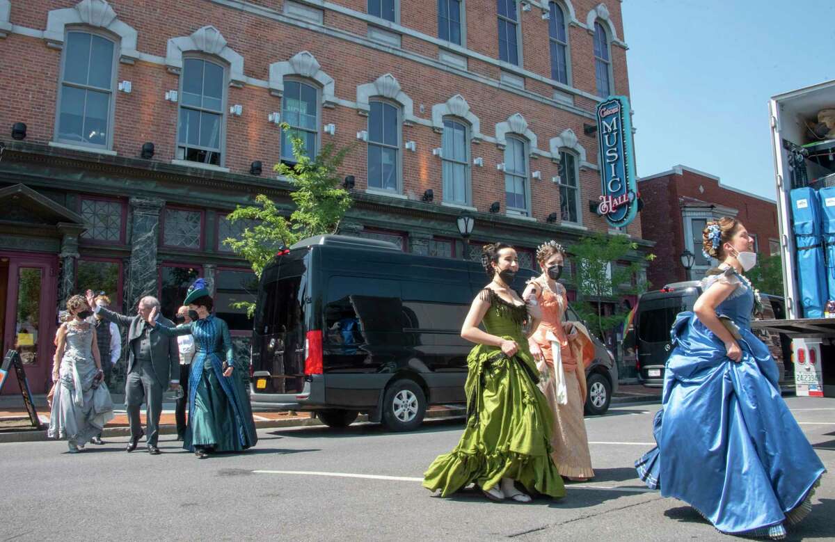 Actors are seen waving to bystanders as they leav for a lunch break in front of the Cohoes Music Hall as filming for the HBO series ‘The GIlded Age’ is taking place in the hall on Monday, Aug. 29, 2022 in Cohoes, N.Y.