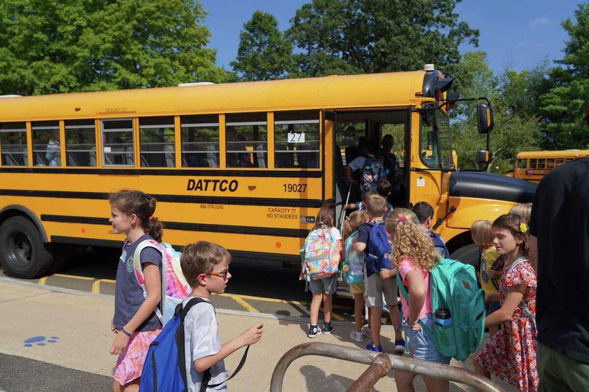 Students of New Canaan South Elementary School get on the buses after the first day of school Aug. 29, 2022