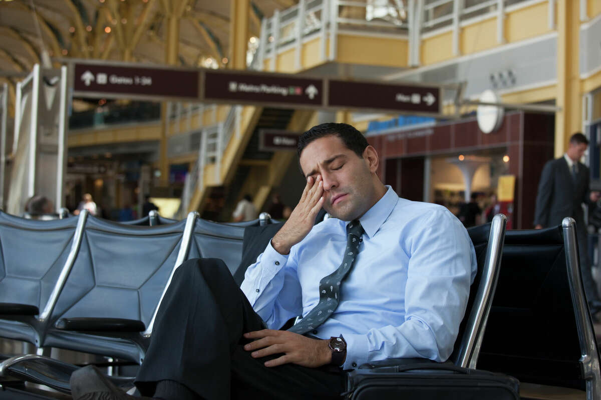 Man coming to grips with yet another airport delay (stock photo)