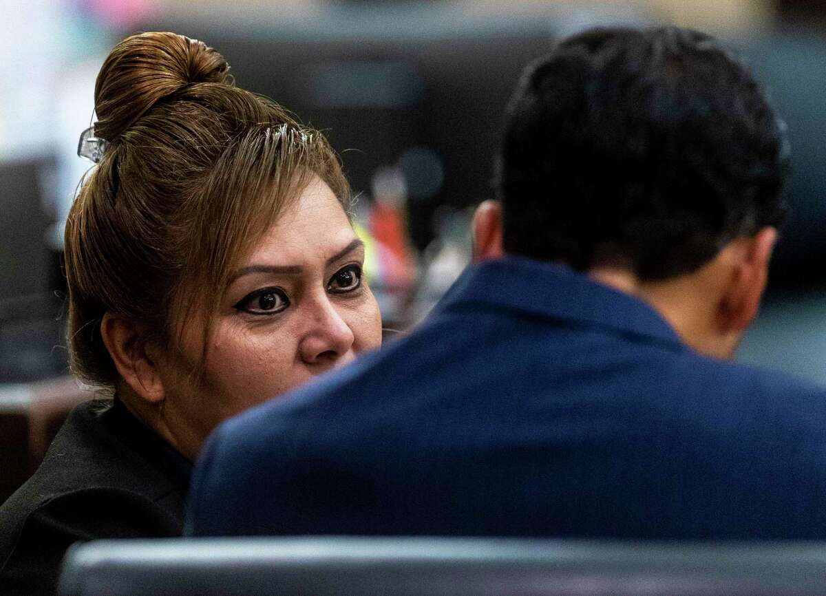 Former Constable Michelle Barrientes Vela, left, talks Monday with defense attorney, Nicholas “Nico” LaHood during her public corruption trial. Vela is charged with two felony counts of tampering with evidence in connection with an Easter Sunday incident in 2019 at a West Side park, where she allegedly coerced a family into giving her $300 in cash to reserve a pavilion they had already paid for.