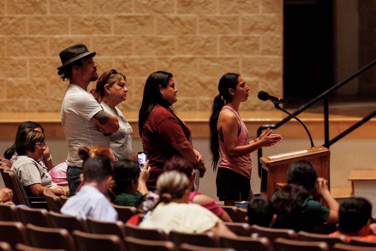 Kimberly Rubio, from right, addresses the Uvalde Consolidated Independent School District board about safety concerns as Gloria Cazares, Berlinda Arreola and Brett Cross stand behind her during a town hall at John H. Harrell Auditorium in Uvalde, Texas, Monday, Aug. 29, 2022.