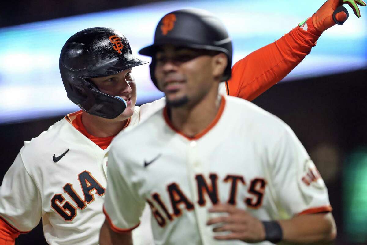San Francisco Giants’ Joc Pederson celebrates with LaMonte Wade, Jr. after his 2-run home run in 4th inning against San Diego Padres during MLB game at Oracle Park in San Francisco, Calif., on Monday, August 29, 2022.