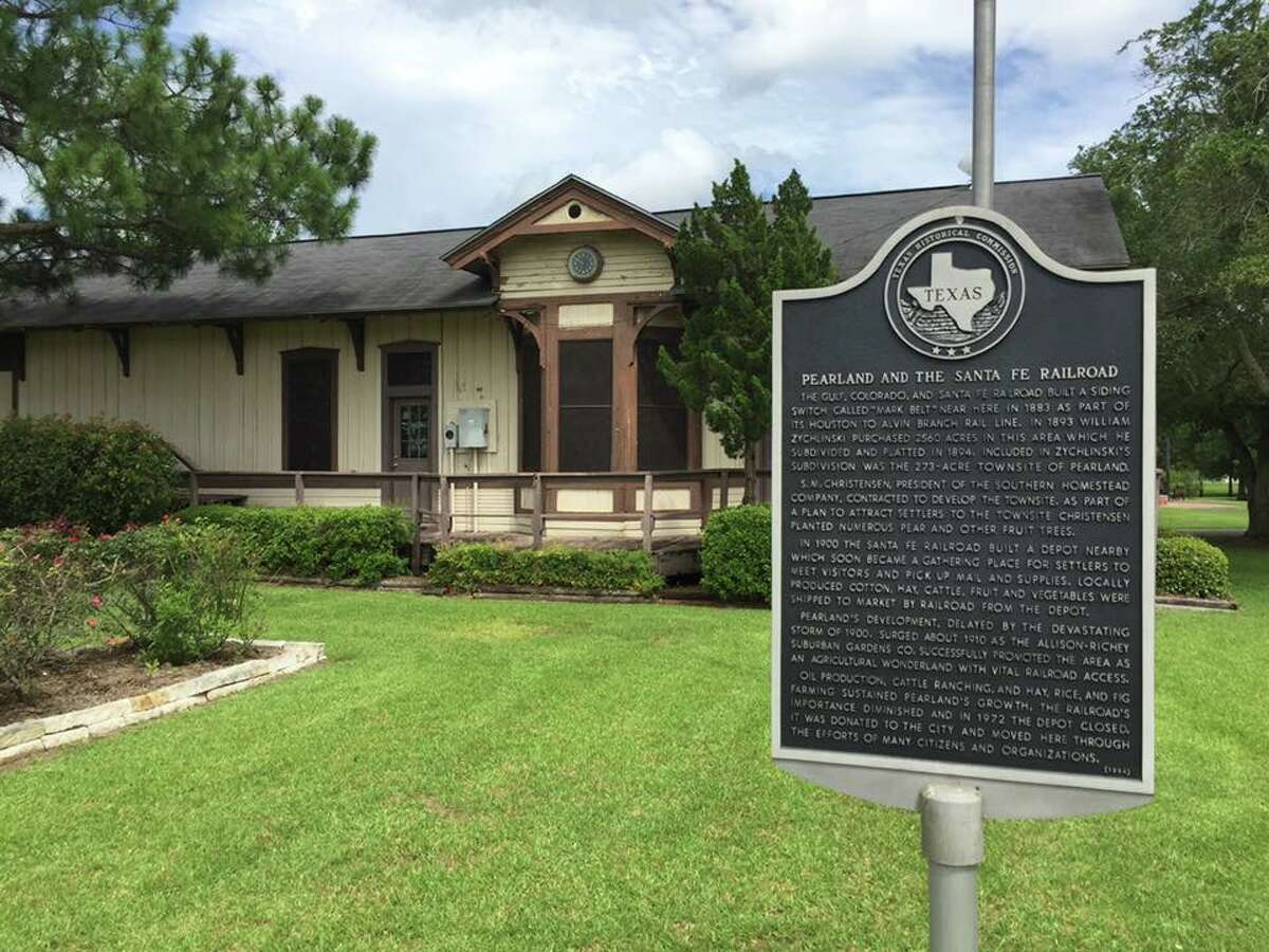 A historical marker is in front of Sante Fe Railroad Depot.