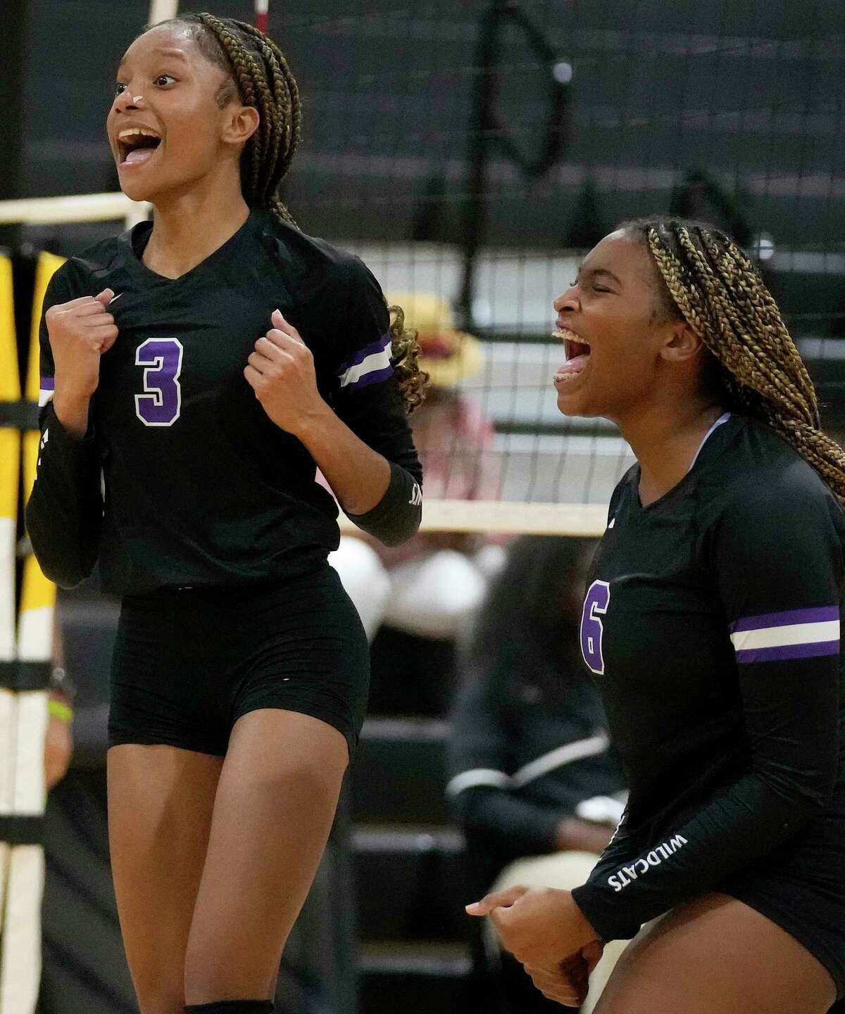 Humble's Trabrece Marbley (3) celebrates her point with Jada James during a high school volleyball match against Eisenhower, Tuesday, Aug. 23, 2022, in Houston.
