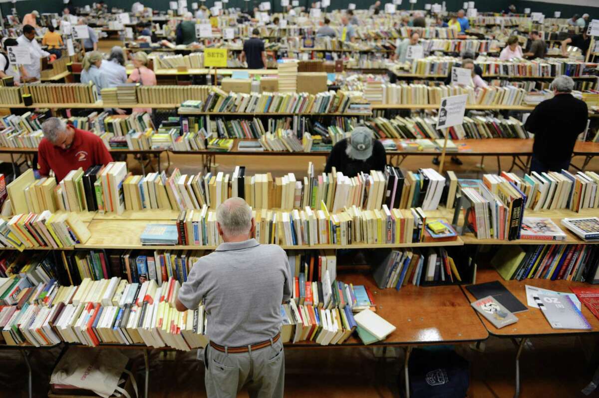 People browse the immense selection of books at the 53rd annual Mark Twain Library Book Fair at the Redding Community Center in Redding, Conn. on Friday, Aug. 30, 2013. Dealers, collectors and readers flocked to the sale ealry Friday morning to grab books by the boxload. The fair continues through Monday.