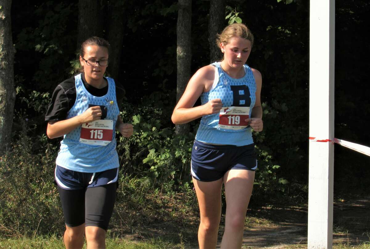 Brethren's Autumn Harris (left) and Olivia Sexton compete in the 2022 Pete Moss Invitational on Aug. 26 at Benzie Central High School.