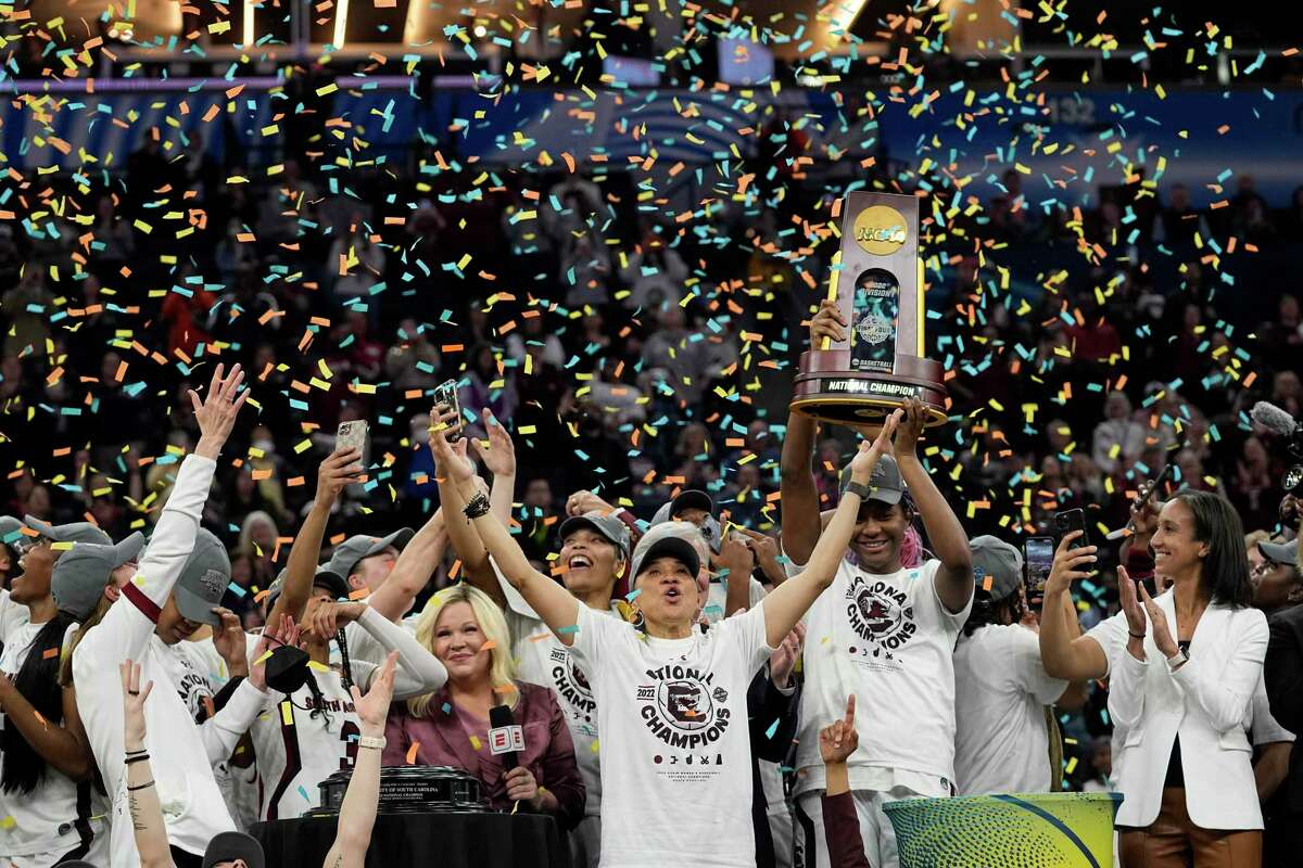 BANNED UNTIL NCAA REPORT IS RELEASE - FILES - South Carolina head coach Dawn Staley plays college basketball in the final round of the Women's Final Four NCAA tournament against UConn in Minneapolis on Sunday, April 3, 2022. celebrate with her team after the game. South Carolina won her 64-49 and won. According to her NCAA report examining her 50th anniversary of Title IX, the number of women competing at the highest level of collegiate athletics continues to grow along with the widening funding gap between male and female sports programs.  (AP Photo/Eric Gay, File)