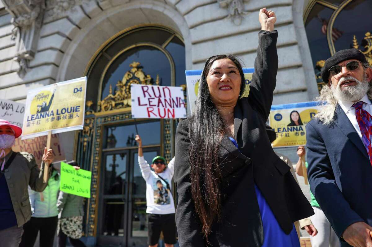 Leanna Louie raises her fist after announcing a lawsuit against San Francisco for scrubbing her from the ballot as a candidate for District Four supervisor over residency issues.