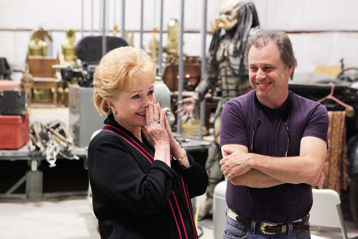 Debbie Reynolds and son Todd Fisher share a laugh while the Predator looks on in the background in one of the warehouses on their 44-acre Central Coast estate named Freedom Farms. The property was recently listed for $2.85 million.