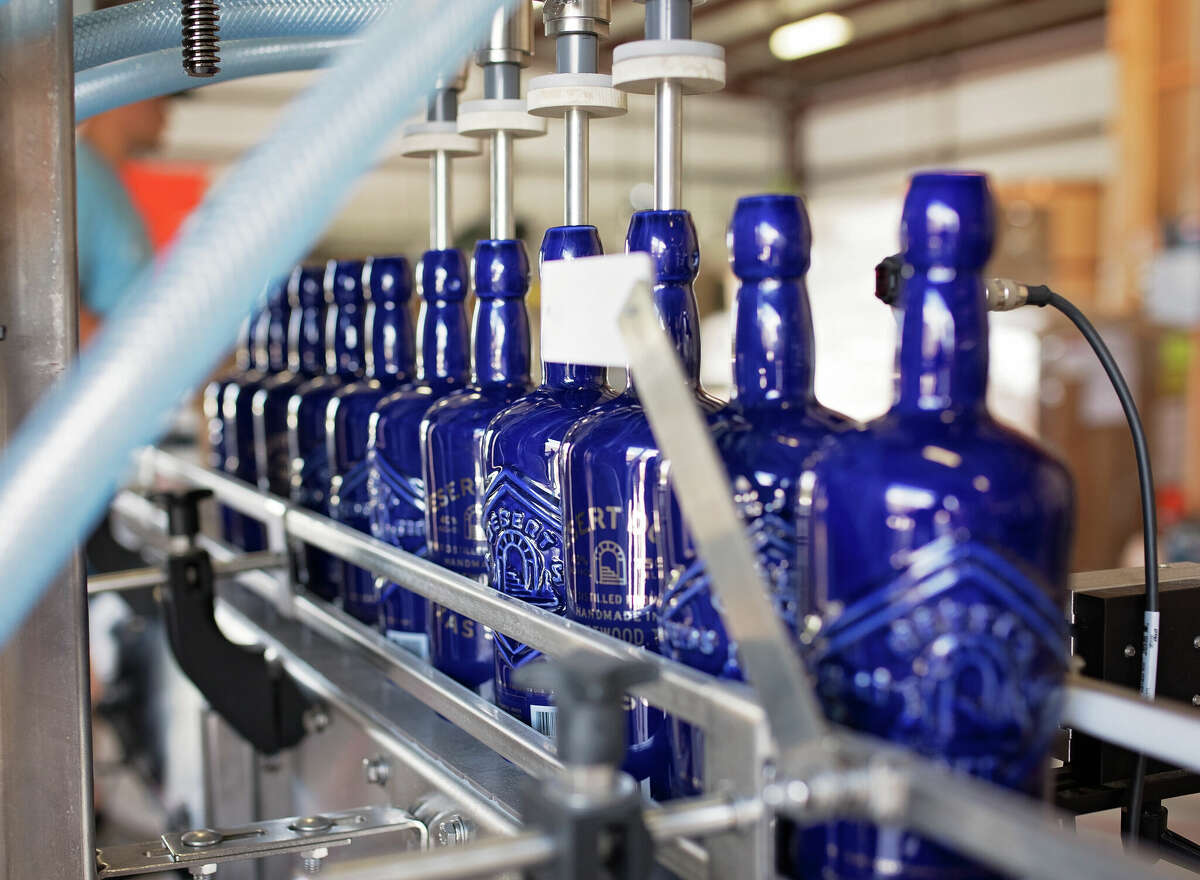 Bottles of Desert Door Texas Sotol are poured at the brand's distillery in Driftwood, Texas. The liquor is similar to agave and is made with plants that grow wild across the Southwest.