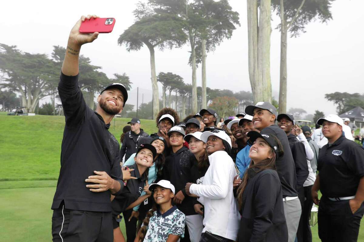 Steph Curry takes a selfie with golfers at his Underrated Golf Tour championships at the Fleming 9 Course in San Francisco, Calif. on Tuesday, Aug. 30, 2022. Steph Curry is a leader in promoting gender equity and diversity in golf.