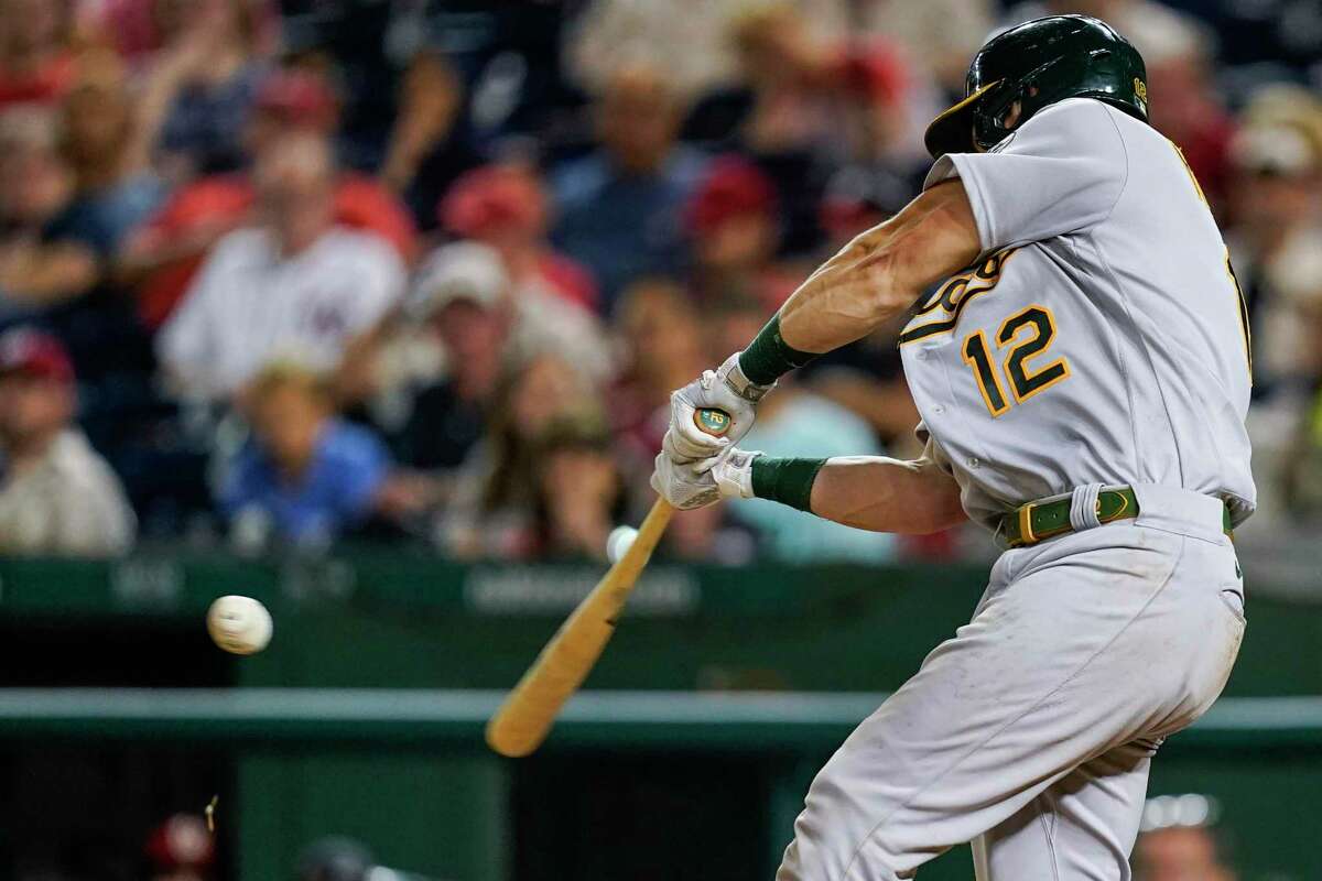 Oakland Athletics' Sean Murphy hits a grand slam during the fifth inning of the team's baseball game against the Washington Nationals at Nationals Park, Tuesday, Aug. 30, 2022, in Washington. (AP Photo/Alex Brandon)