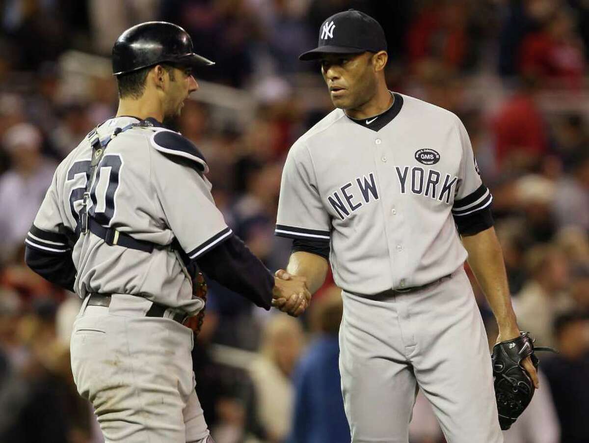 MINNEAPOLIS - OCTOBER 06: Mariano Rivera #42 of the New York Yankees celebrates the win with teammate Jorge Posada #20 after game one of the ALDS against the Minnesota Twins on October 6, 2010 at Target Field in Minneapolis, Minnesota. The Yankees defeated the Twins 6-4. (Photo by Elsa/Getty Images) *** Local Caption *** Mariano Rivera;Jorge Posada