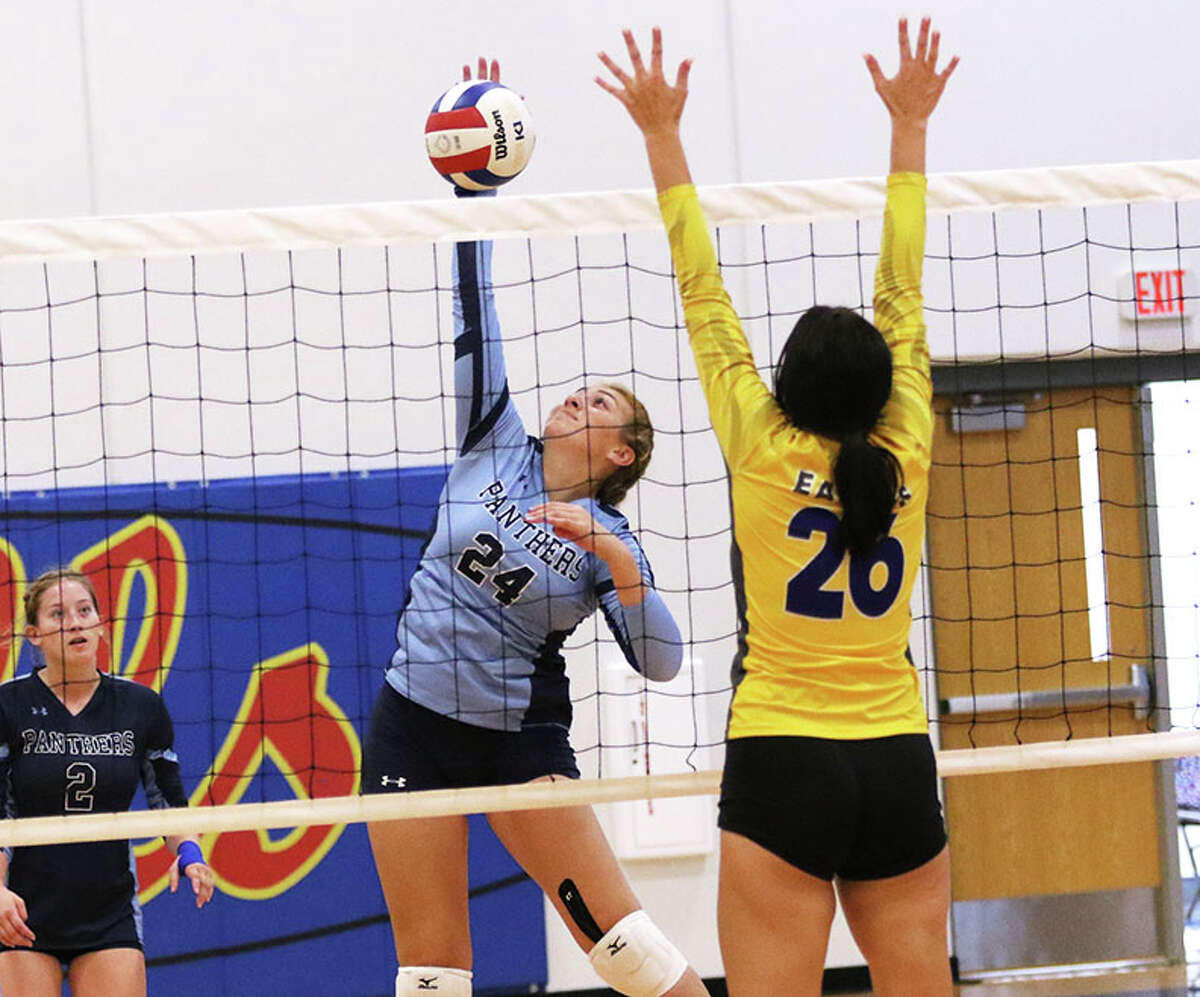 Jersey's Ashlyn Brown (left), shown hitting past the block of CM's Camryn Gehrs on Saturday at the Roxana Tourney, had six kills in the Panthers' three-set win Tuesday at Carrollton.