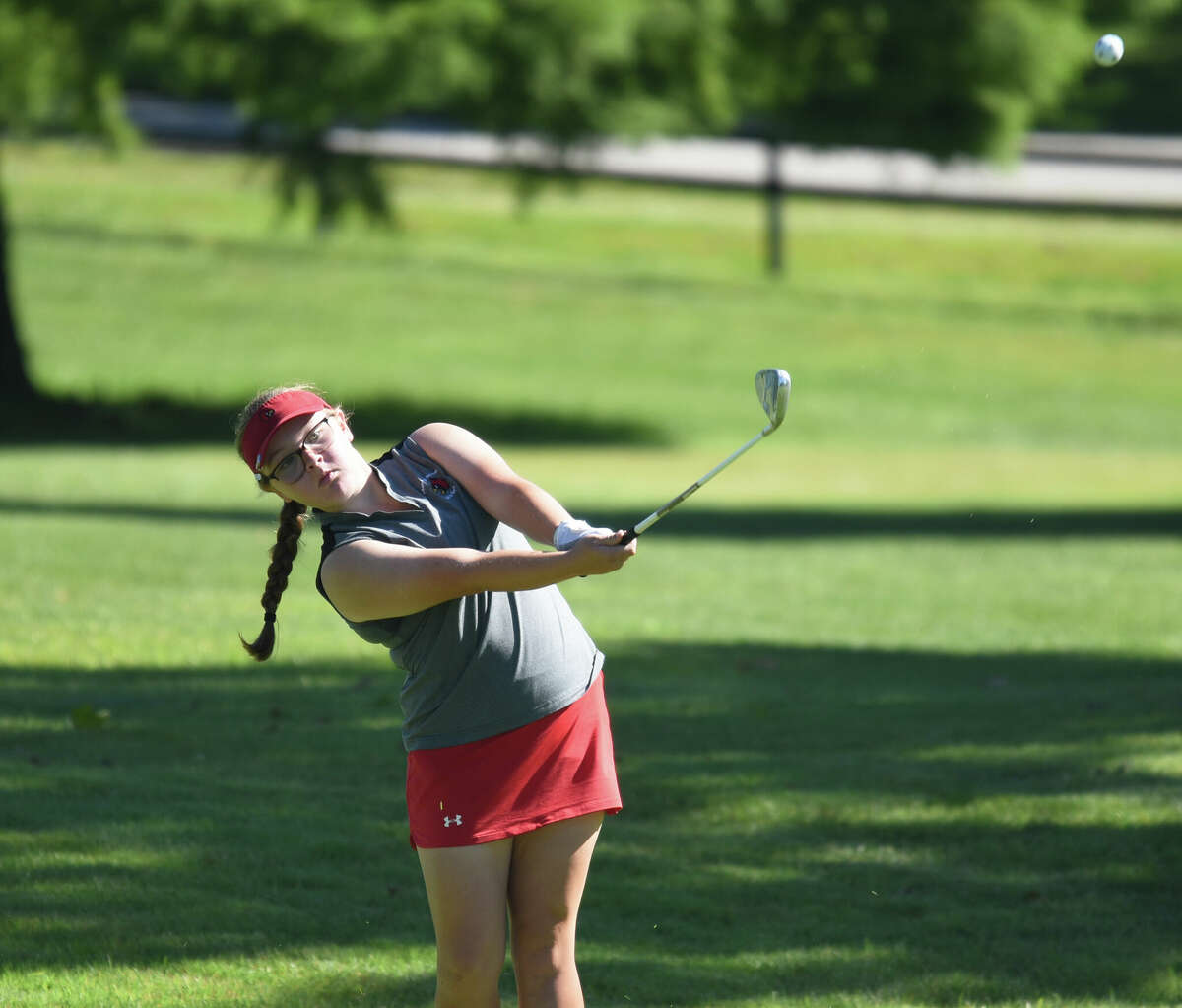 Alton's Addison Kenney hits a shot on hole No. 1 at Belk Park in the SWC Tournament on Tuesday in Wood River. Kenney is in eighth place in the 36-hole tourney after shooting 85.