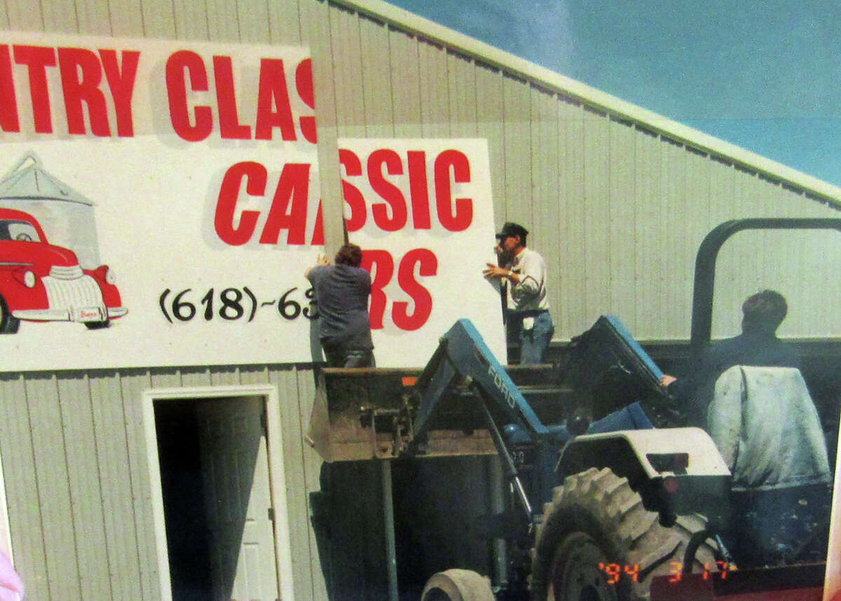 This photo is from May 1999, when Russ and Anita were installing the sign for their new business, Country Classic Cars in Staunton. The couple recently retired and sold the business to Josh and Candi Laurent.