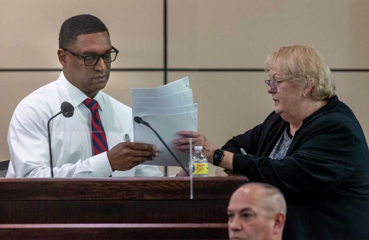 Texas Ranger Bradley Freeman, left, is shown documents by prosecutor Dawn McCraw on Monday during the trial of former Constable Michelle Barrientes Vela on evidence tampering charges. The judge in the trial told Freeman she planned to hold him in contempt of court for mentioning other accusations against Vela on Tuesday that were to be kept from the jury.