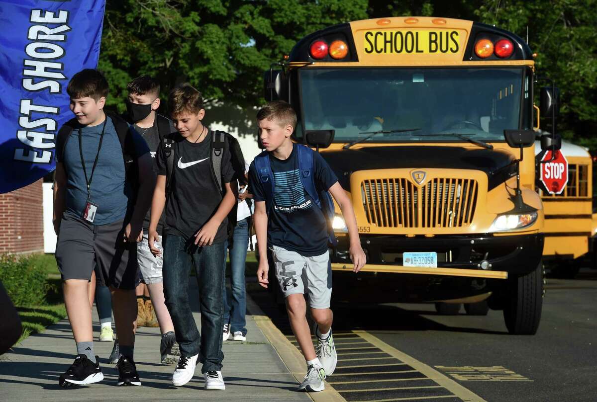 Students exit buses for the first day of school at East Shore Middle School in Milford on August 31, 2022.