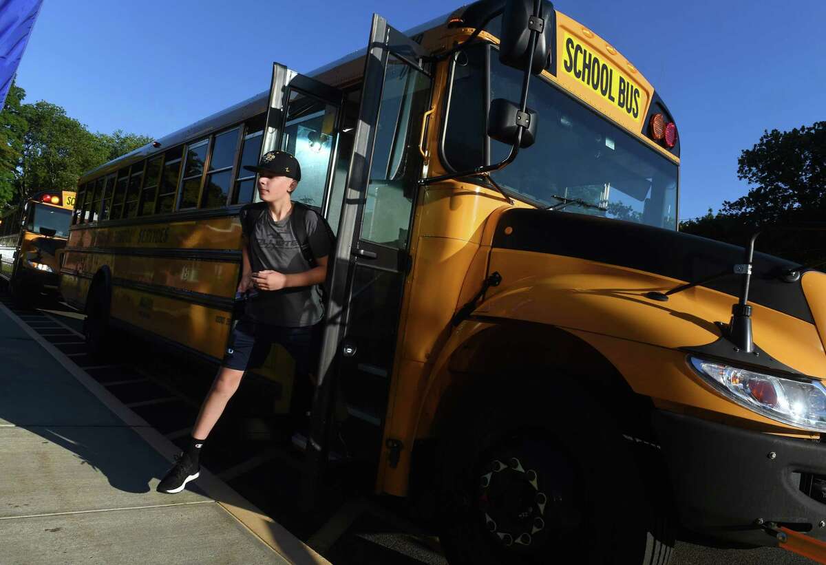 Students exit buses for the first day of school at East Shore Middle School in Milford on August 31, 2022.