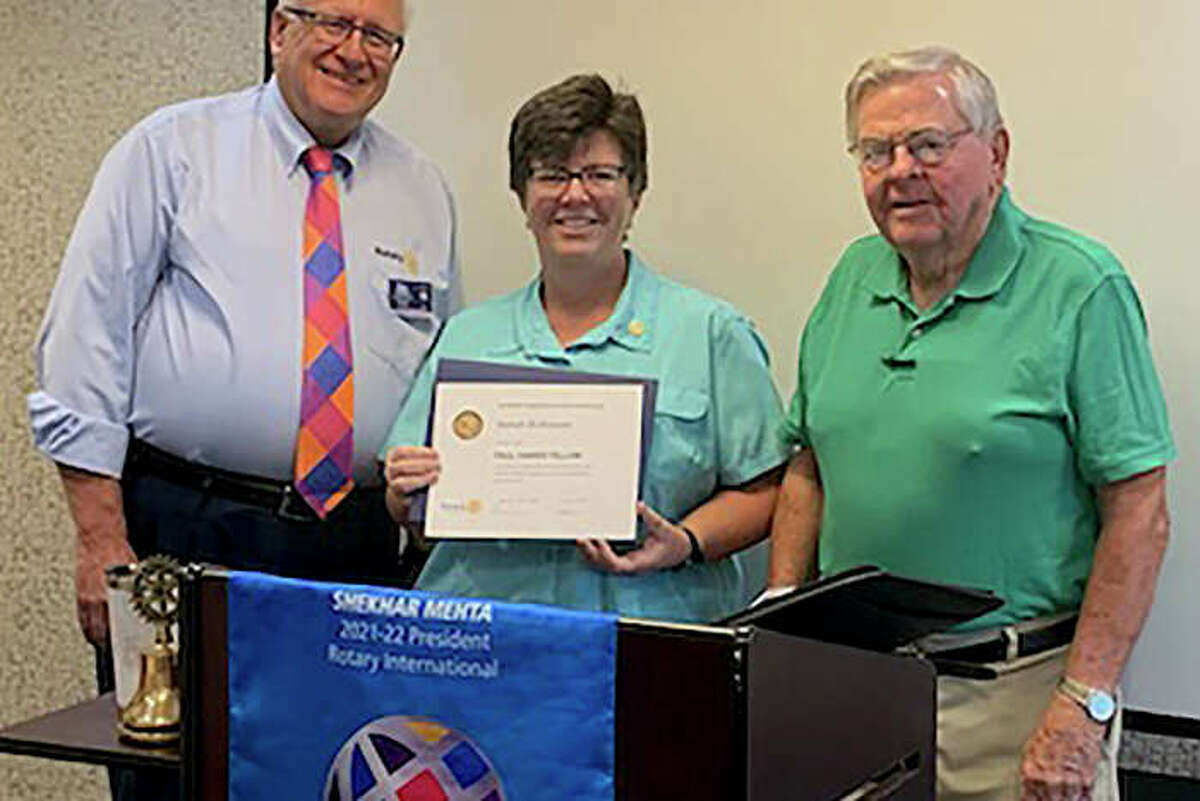 Sunrise Rotary Club members Dan O'Brien (left) and Don Pigg (right) present Sarah Robinson with a Paul Harris Fellowship in July, noting that Robinson exemplifies the club's "Service Above Self" motto as director of New Directions Warming & Cooling Center and as a Sunrise Rotary member.
