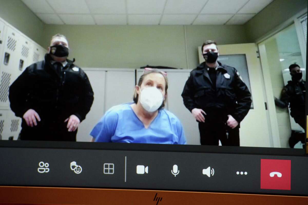 Ellen Wink appears on a video monitor during her arraignment in Stamford Superior Court, in Stamford, Conn. Jan. 21, 2022. Wink is charged in the shooting death on Thursday of Kurt Lametta in a home she owns in Norwalk.