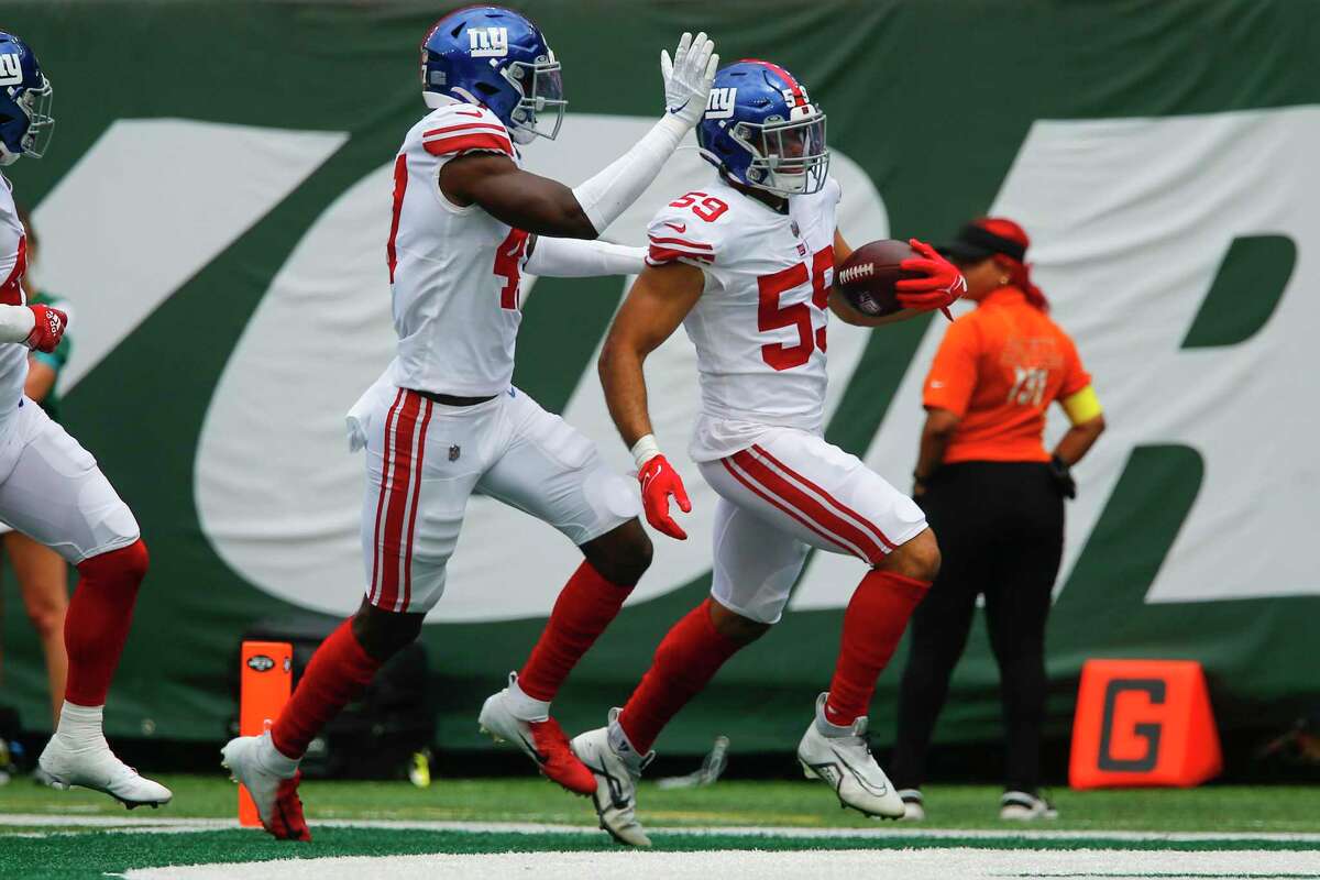 New York Giants linebacker Austin Calitro (59) runs in a touchdown in the first half of a preseason NFL football game against the New York Jets, Sunday, Aug. 28, 2022, in East Rutherford, N.J. (AP Photo/John Munson)