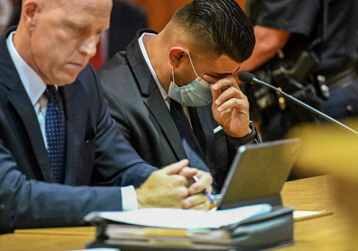 Lee Kindlon, attorney for Nauman Hussain, left, and Nauman Hussain, who ran the limo company involved in the 2018 crash in Schoharie that killed 20 people, listens to a victim impact statement during a proceeding in Schoharie County court on Wednesday, Aug. 31, 2021, in Schoharie, N.Y.