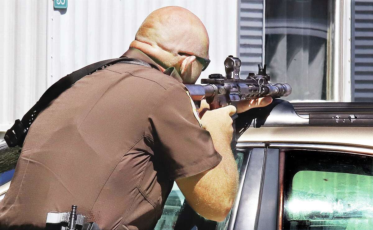 John Badman|The Telegraph A Madison County Deputy Sheriff keeps an assault rifle trained on the front door of aa Bethalto mobile home until the alleged shooter surrendered to police.