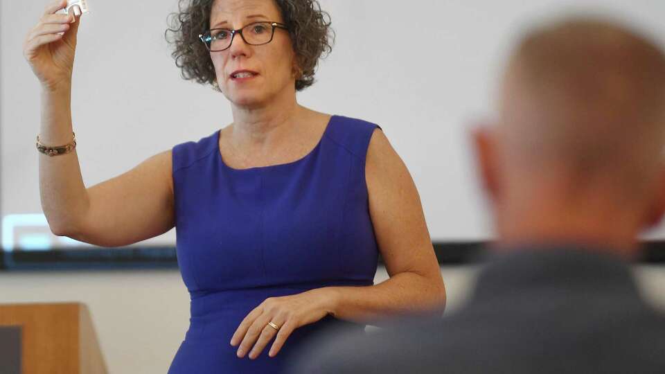 Positive Directions Prevention Director Margaret Watt discusses the application of opioid overdose treatment Narcan, before distributing free Narcan kits on International Overdose Awareness Day at the Westport Library in Westport, Conn. on Wednesday, August 31, 2022.