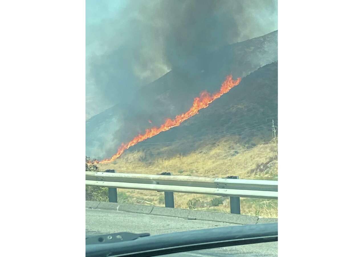 A fast-growing brush fire forced the closure of I-5 near Los Angeles on Wednesday afternoon as California braces for the dual onslaught of a heat wave and Labor Day weekend travel.
