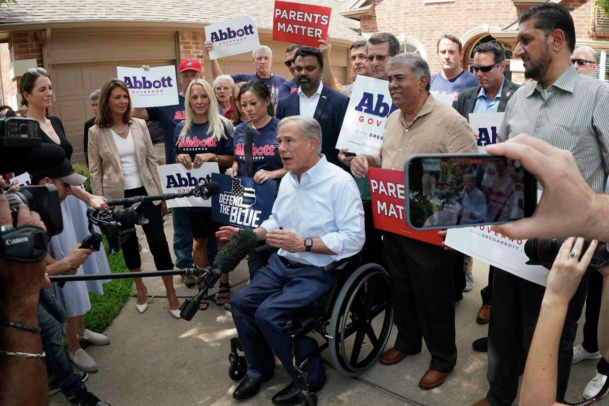 Texas Governor Greg Abbott talks with the media after a visit with suburban Allen, Texas resident Maggie Pitka during a photo opportunity heralding the ceremonial ‘knock’ on the 2,000,000th door of the election cycle. CREDIT: Louis DeLuca for The Houston Chronicle