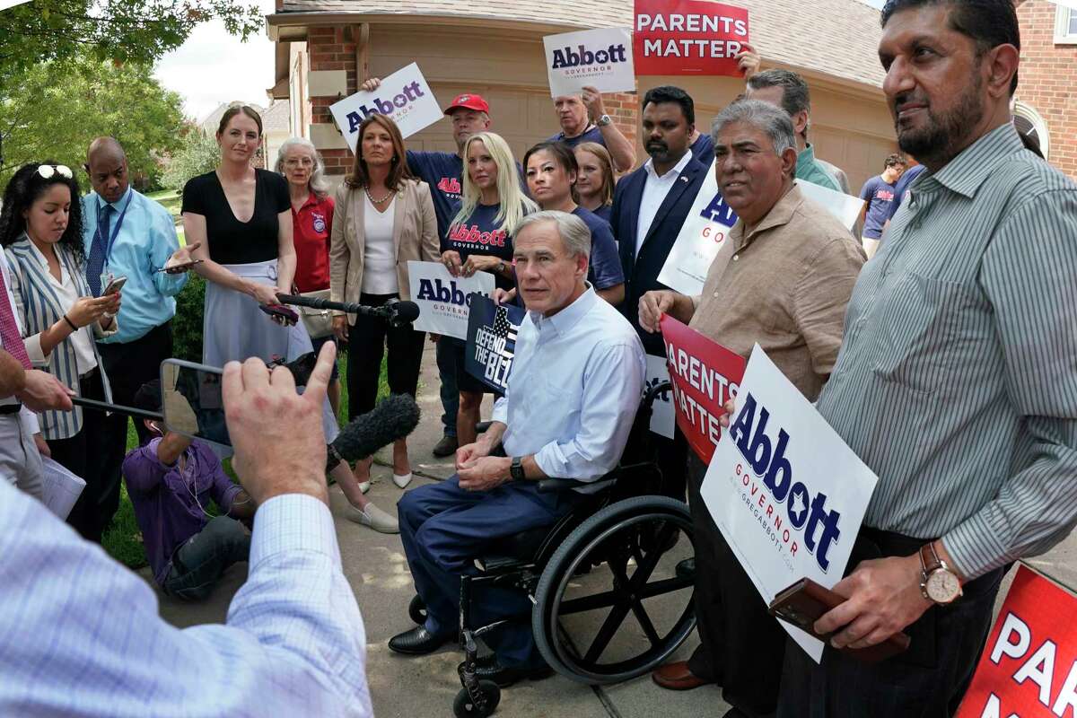 Texas Governor Greg Abbott talks with the media after a visit with Allen, Texas resident Maggie Pitka during a photo opportunity heralding the ceremonial ‘knock’ on the 2,000,000th door of the election cycle. CREDIT: Louis DeLuca for The Houston Chronicle
