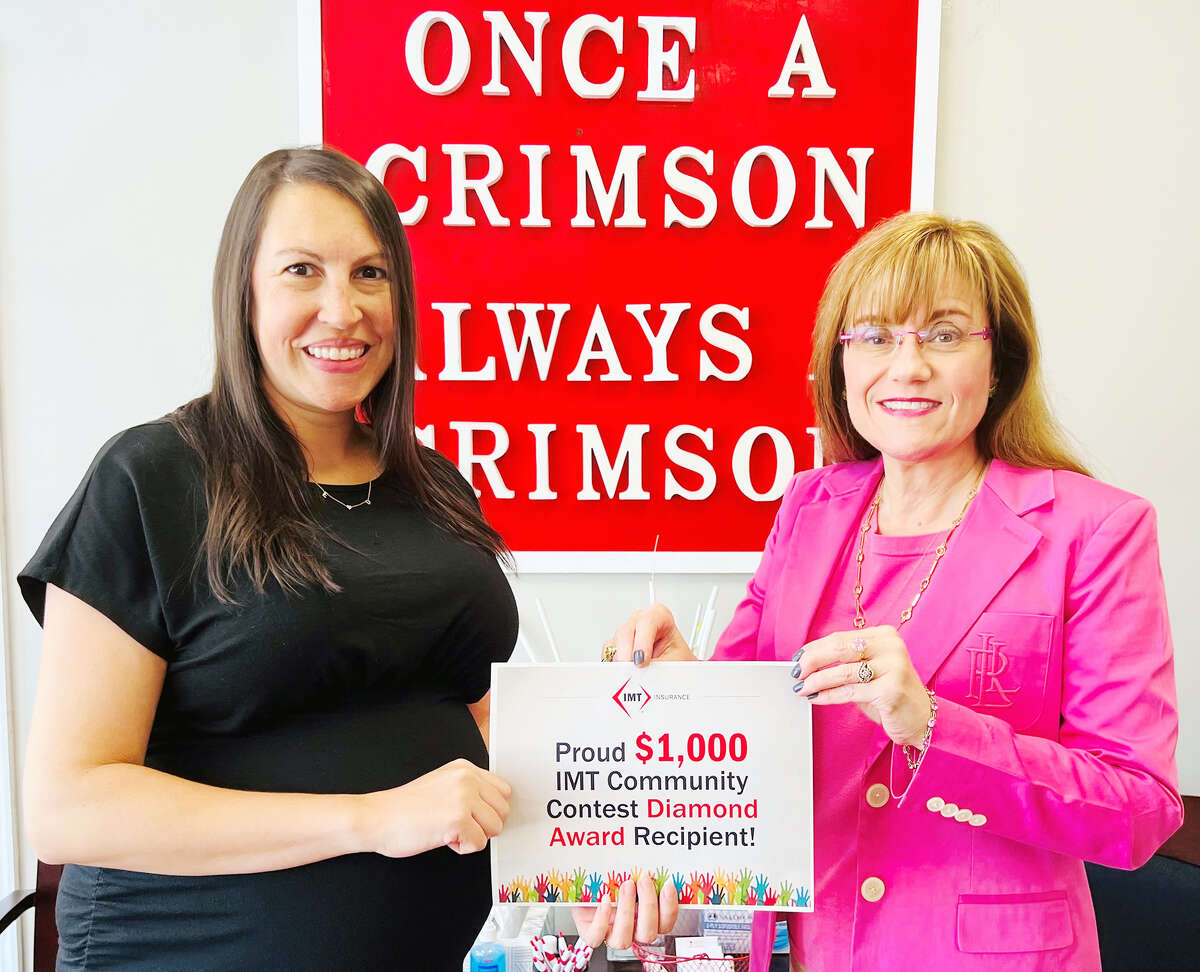 Nikki Henry Whalen (left), a sales executive with Dimond Bros. Insurance in Jacksonville, presents a certificate representing a $1,000 donation from IMT Insurance to the Jacksonville Public Schools Foundation to Leslie DeFrates, the foundation’s executive director.