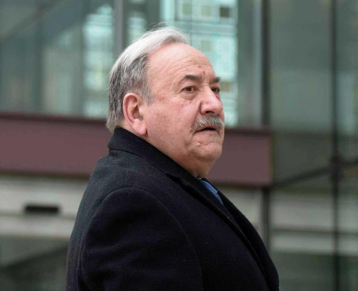 Former Stamford Democratic City Committee Chairman John Mallozzi enters the Connecticut Superior Court in Stamford, Conn. Monday, Feb. 11, 2019. Mallozzi is being charged with 14 counts each of filing false statements and second-degree forgery in an identity-theft scheme involving absentee ballots stemming from the 2015 municipal election.