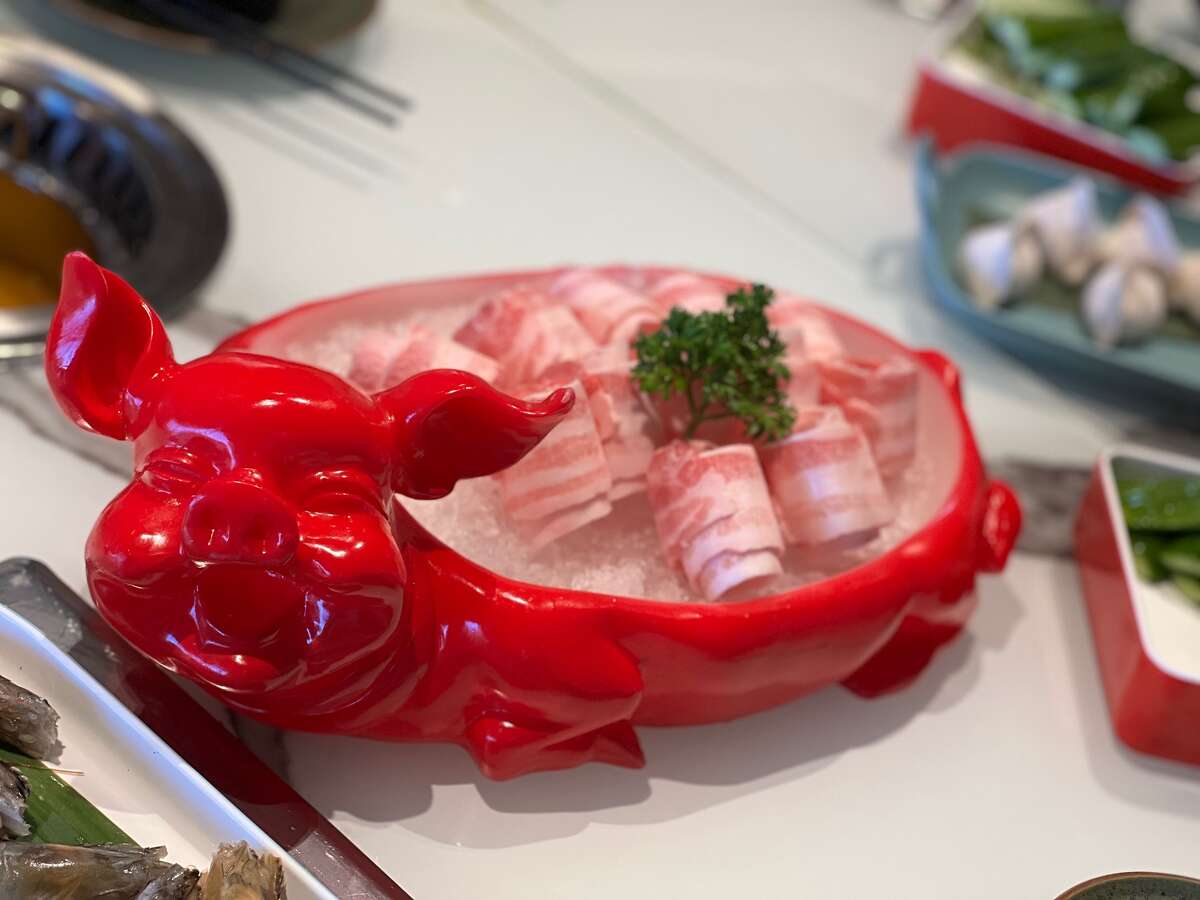 HL Peninsula Hotpot & Grill recently opened in Burlingame with over-the-top serving platters, like this pig-shaped plate holding Kurobata pork collar.