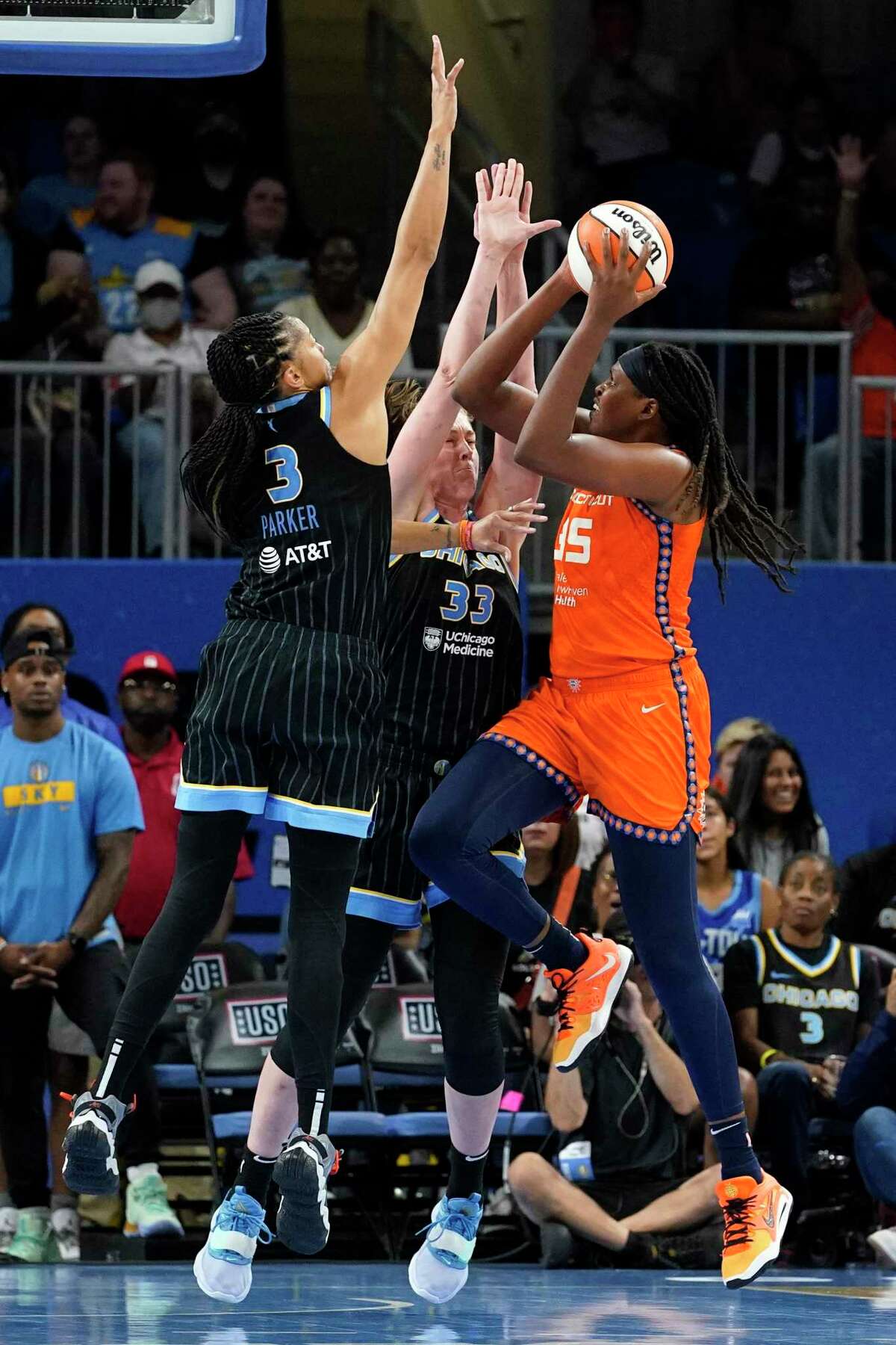 Chicago Sky forward Candace Parker, left, and forward Emma Meesseman, center, defend against Connecticut Sun forward Jonquel Jones during the second half of Game 2 in a WNBA semifinal Wednesday in Chicago.