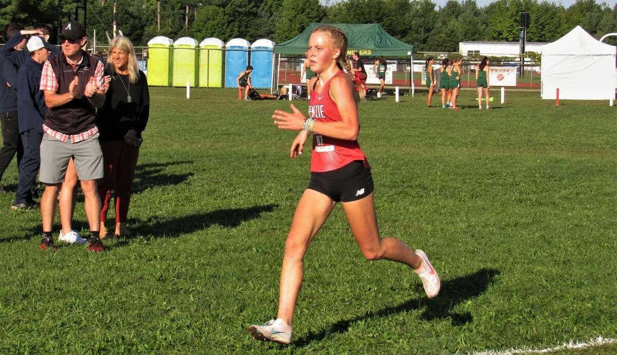 Benzie Central junior Mylie Kelly dashes through the final strech during the 2022 Pete Moss Invitational on Aug. 27 at Benzie Central High School. 