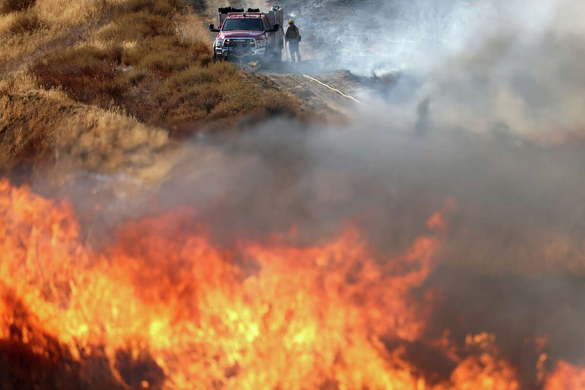A firefighter works as the Route Fire burns on August 31, 2022 near Castaic, California. Evacuations have been ordered as the brush fire has scorched more than 4,600 acres and closed down the 5 freeway at the start of a brutal heat wave in Southern California. The National Weather Service issued an Excessive Heat Warning for most of Southern California through Labor Day. Climate models almost unanimously predict that heat waves will become more intense and frequent as the planet continues to warm. 