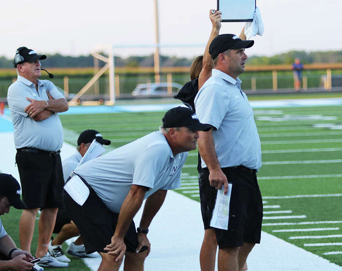 North Mac head coach Patrick Bowman (right) watches his team against Carlinville in a Week 1 SCC football game last Friday in Virden. At left is Patrick's dad and assistant coach Dan Bowman, who won 284 career games as head coach at Greenfield and Jacksonville Routt.