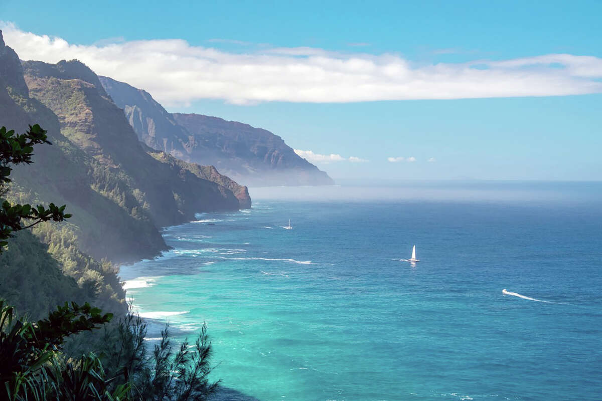 The Napali Coast on Kauai, Hawaii, features tall sea cliffs and crystal-blue waters.