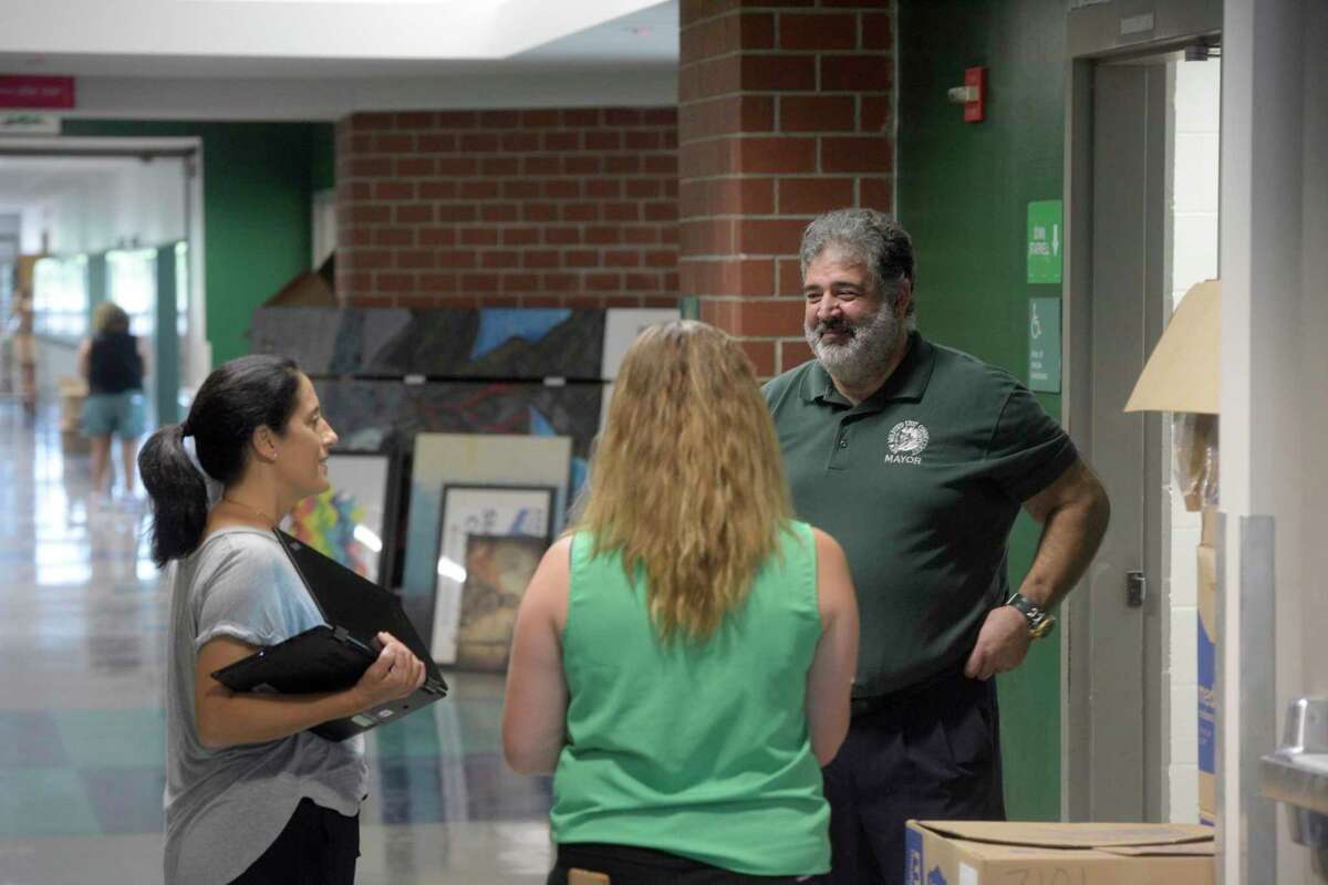 Mayor Pete Bass talks with teachers during a tour of New Milford High School. The school is on track to open next week after repairs from water damage from the recent fire. Wednesday, August 31, 2022, New Milford, Conn.