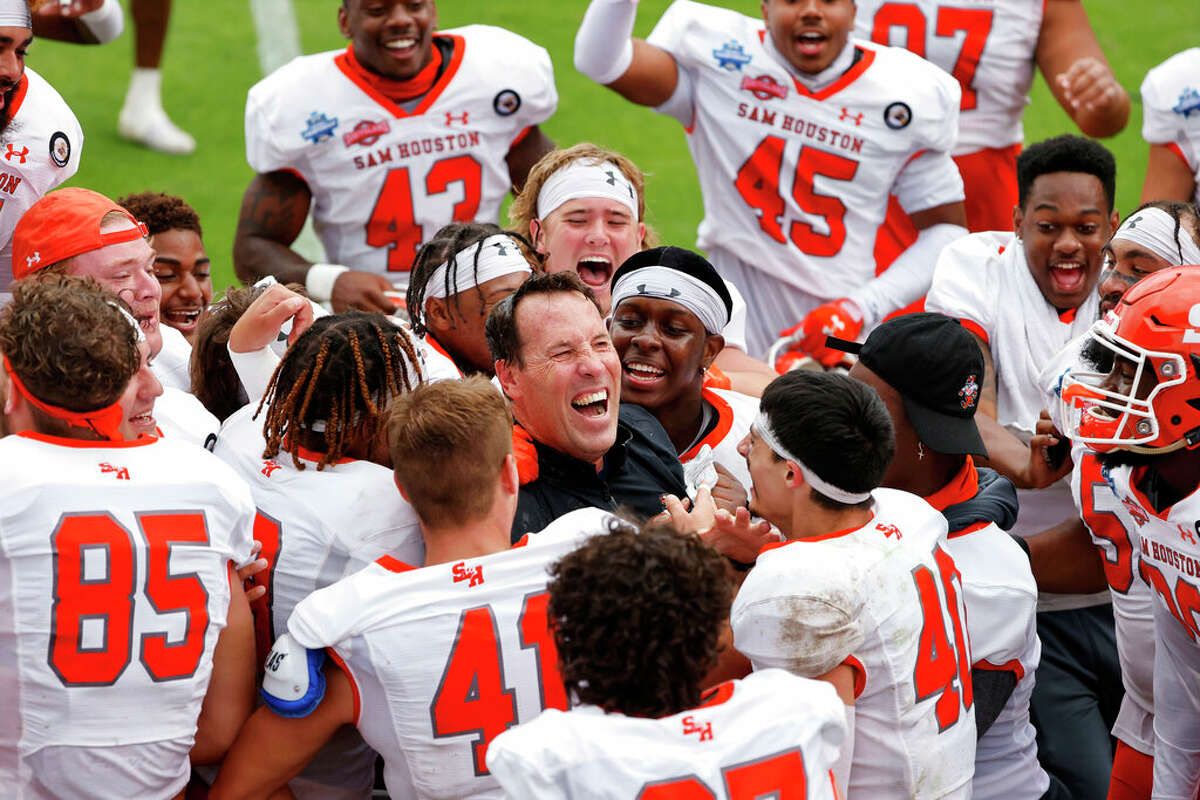 Sam Houston coach K.C. Keeler, center, led his team to 21 victories in calendar year 2021, none bigger than a 23-21 FCS title game victory over South Dakota State at Fresno.