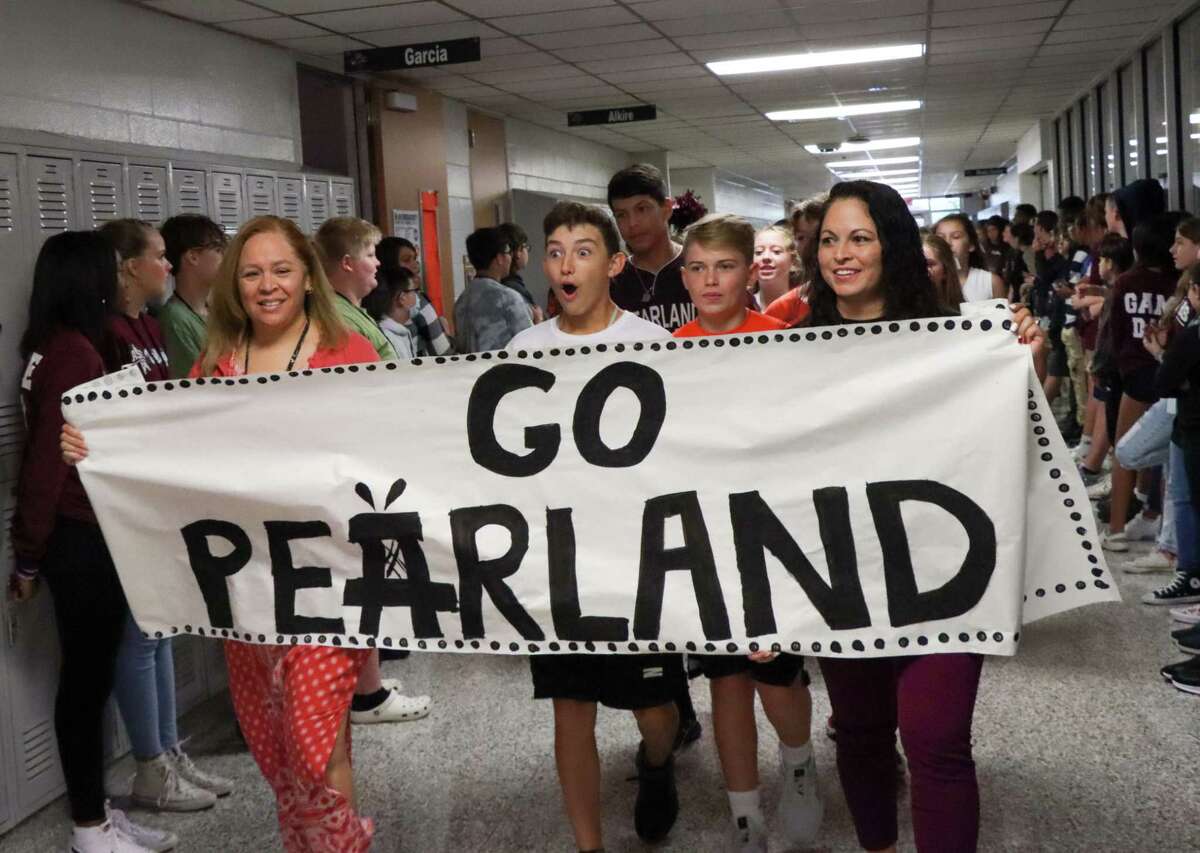 Pearland Little League team player Jackson Wolfe, center, shows surprise at the reaction of students lining the hallways on Sept. 1 at Pearland Junior High East to celebrate the team's participation in the Little League World Series. Behind him is teammate Manuel Castillo, and another team member, Ethan Richardson, is to his right.