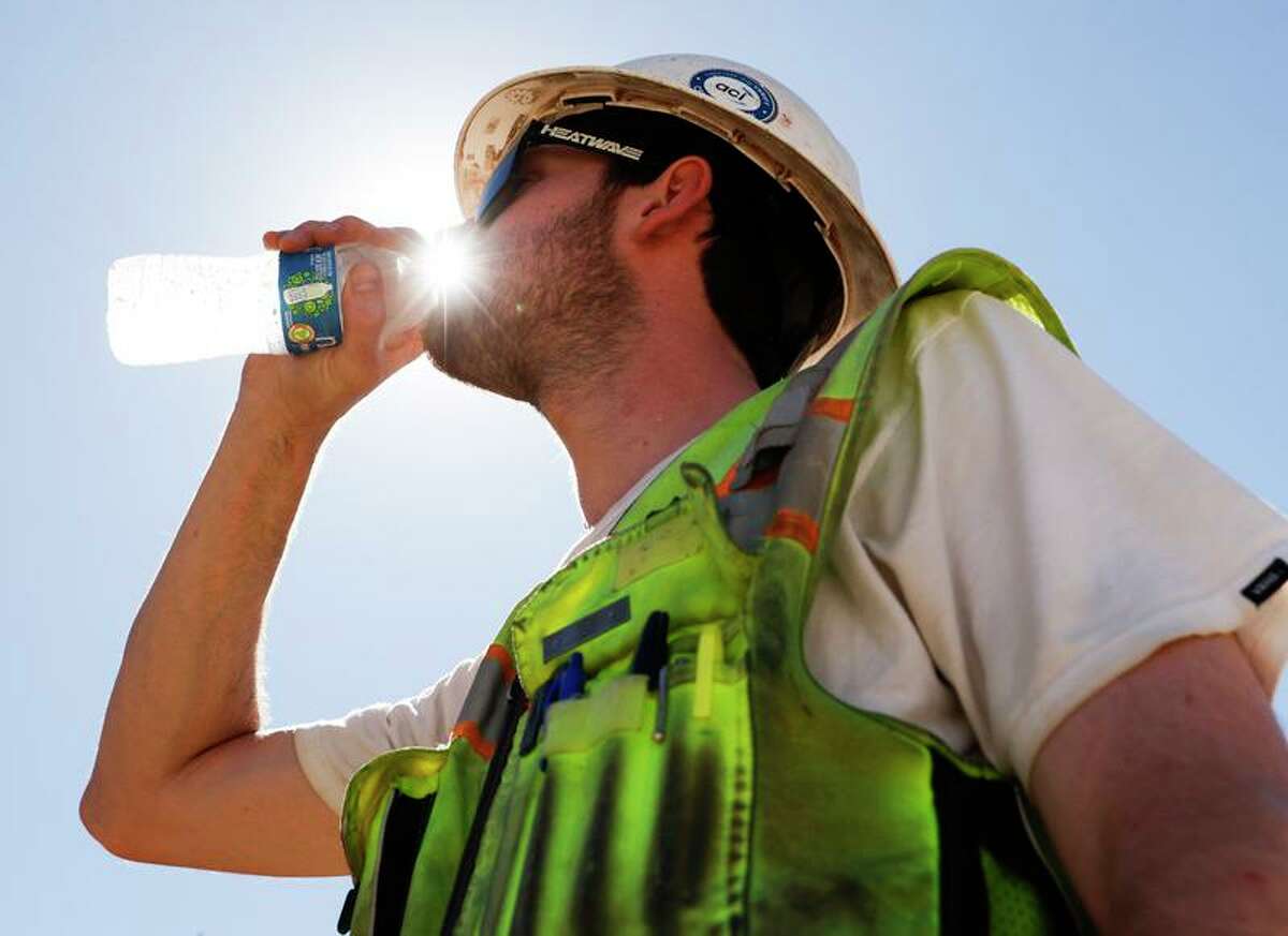 Construction inspector Zach Garner drinks cold water while working on site at the Antioch Desalination Plant as temperatures rise.