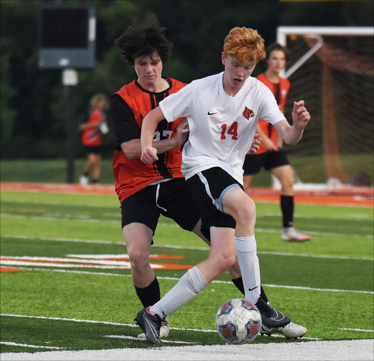Alton's Alex Tuetken shields the ball from Edwardsville's Parker McMillian during Thursday's Southwestern Conference game inside the District 7 Sports Complex in Edwardsville.