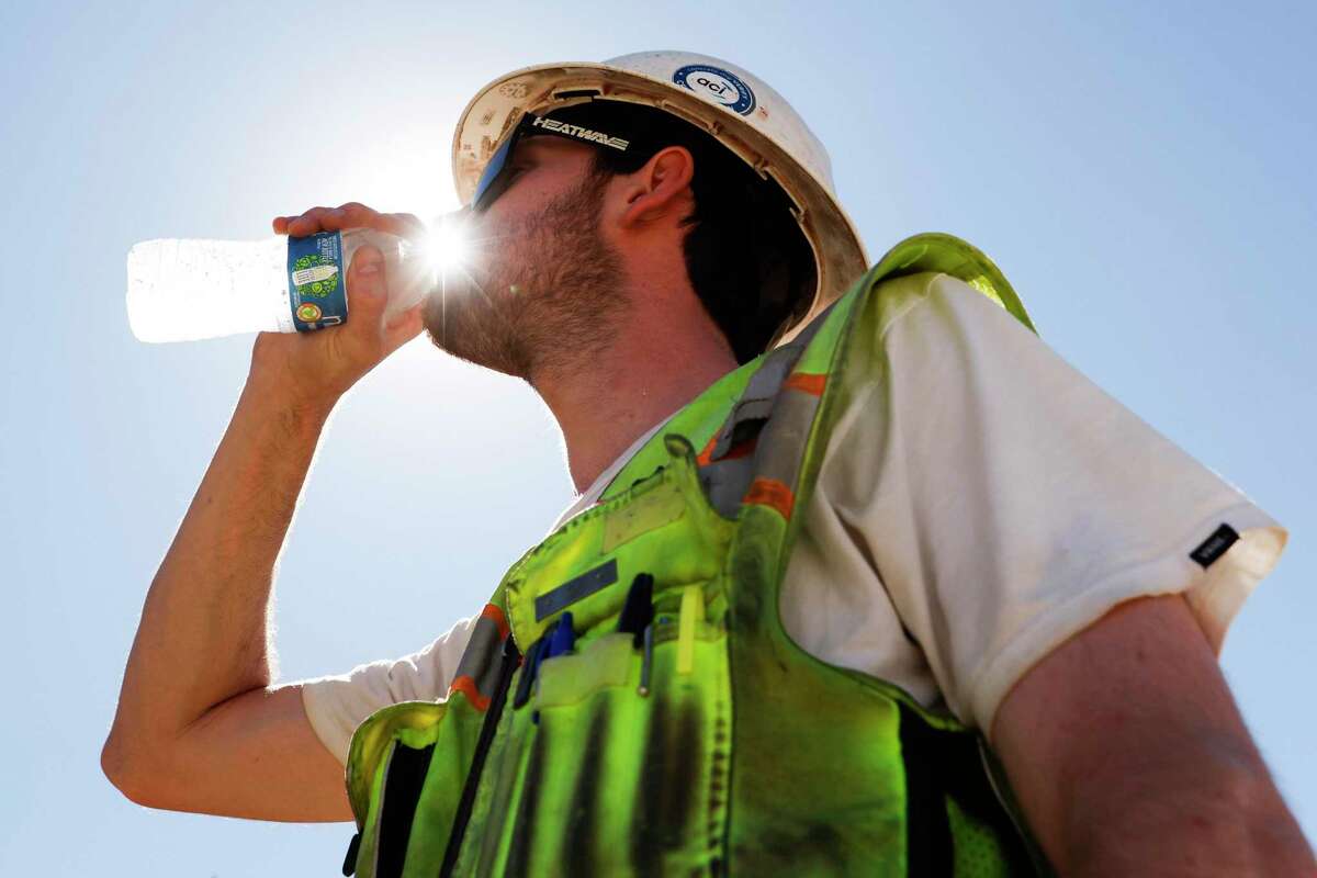 Construction inspector Zach Garner drinks cold water while working under the blazing sun at the Antioch Desalination Plant.