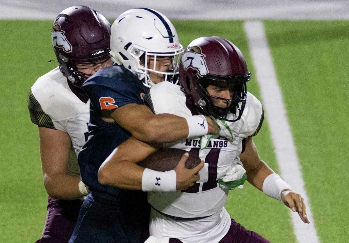 Magnolia West Beau Chumley (11) is tackled by Fort Bend Bush Preston Davis (6) in the second half on September 1, 2022 at Legacy Stadium in Katy, Texas. Magnolia West won 43 to 0.