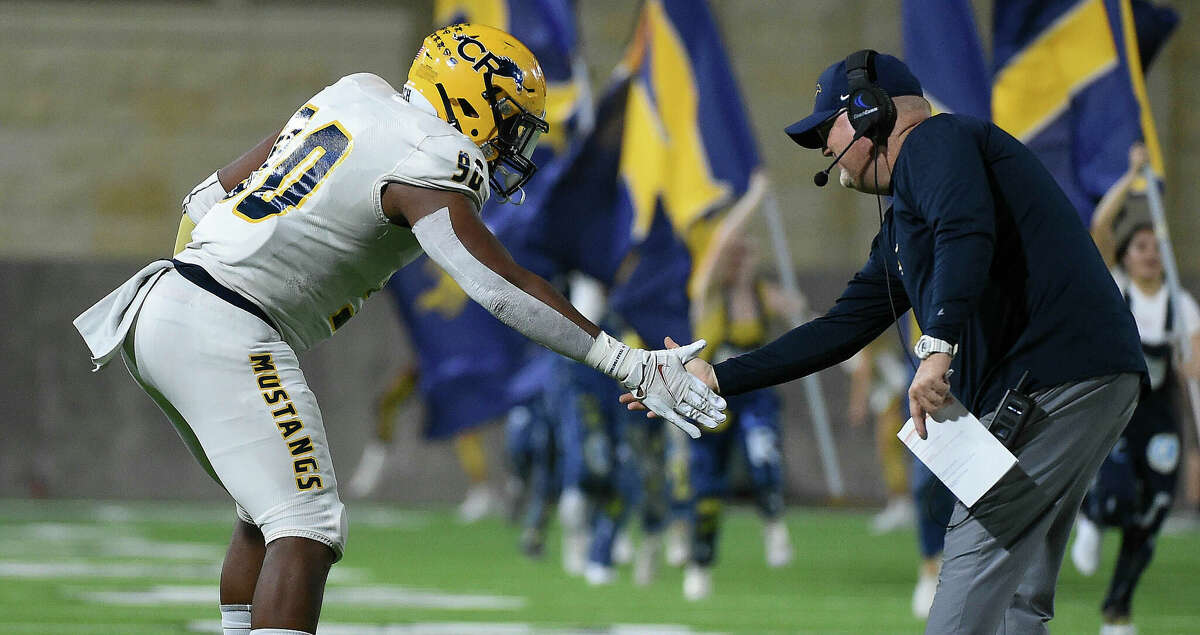 Cypress Ranch tight end Ashton Porter, left, celebrates his touchdown with head coach Sean McAuliffe during the first half of a high school football game against Bridgeland, Saturday, Oct. 9, 2021, in Houston.